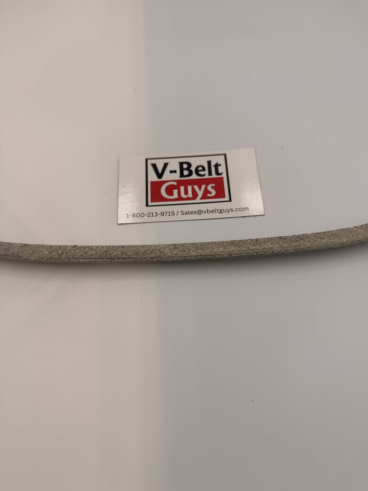 Side profile of aramid wrapped V-belt next to V-Belt Guys card