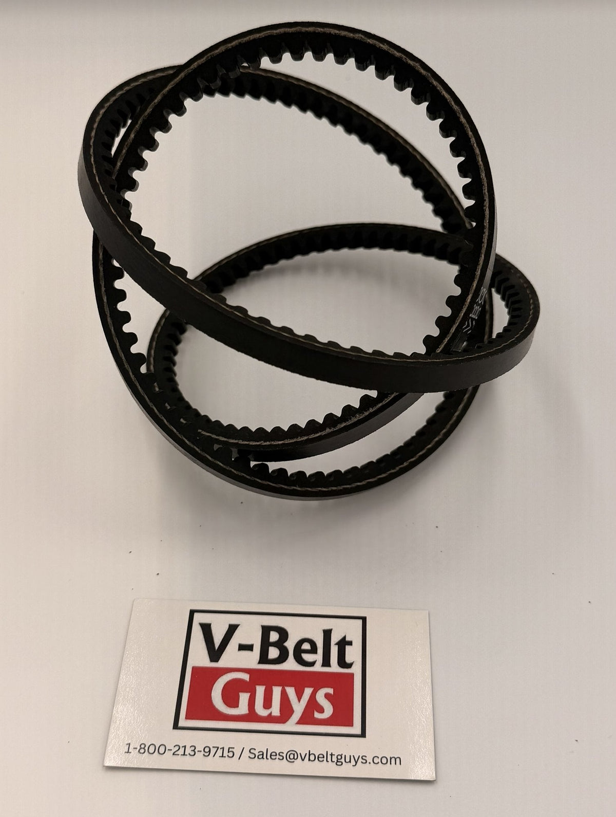 Flexible 3VX cogged wedge V-belt coiled to show the notched underside