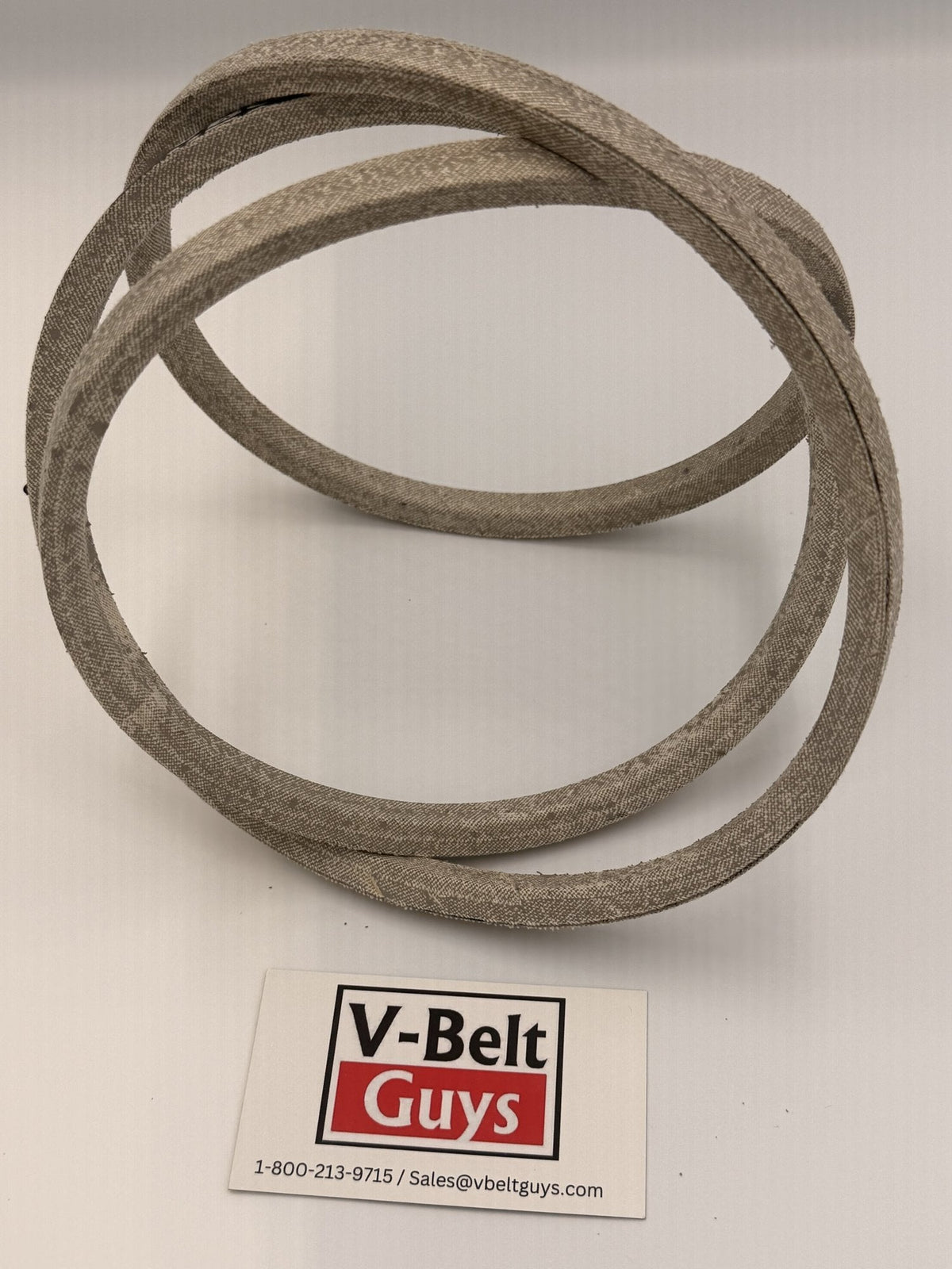 Flexible aramid wrapped V-belt twisted to show both sides of the wrapped cover
